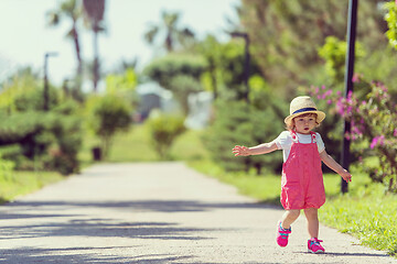 Image showing little girl runing in the summer Park