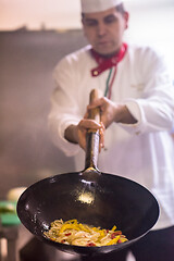 Image showing chef flipping vegetables in wok