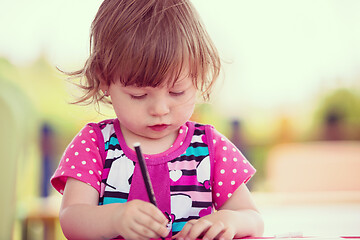 Image showing little girl drawing a colorful pictures