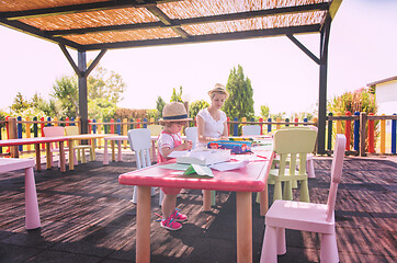 Image showing mom and little daughter drawing a colorful pictures