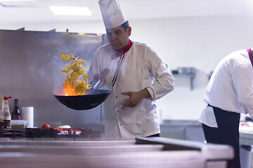 Image showing chef flipping vegetables in wok