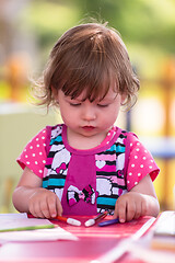 Image showing little girl drawing a colorful pictures