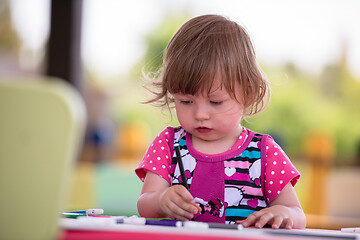 Image showing little girl drawing a colorful pictures