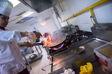 Image showing Chef doing flambe on food