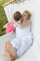 Image showing mother and a little daughter relaxing in a hammock