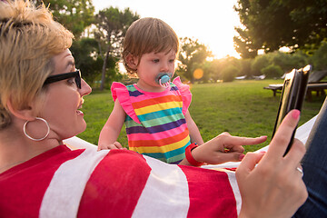 Image showing mom and a little daughter relaxing in a hammock