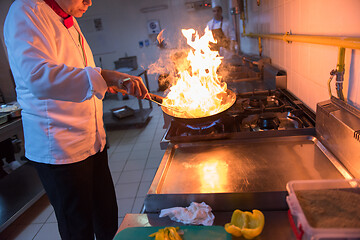 Image showing Chef doing flambe on food