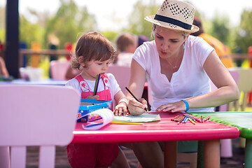 Image showing mom and little daughter drawing a colorful pictures