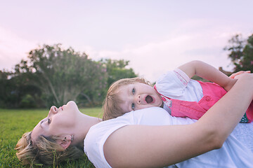 Image showing mother and little daughter playing at backyard