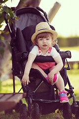 Image showing baby girl sitting in the baby stroller