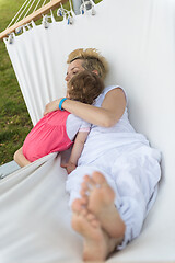 Image showing mother and a little daughter relaxing in a hammock