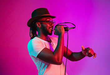 Image showing Young african-american jazz musician singing a song