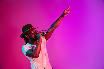 Image showing Young african-american jazz musician singing a song