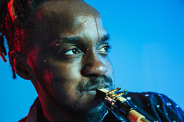 Image showing Young african-american jazz musician playing the saxophone