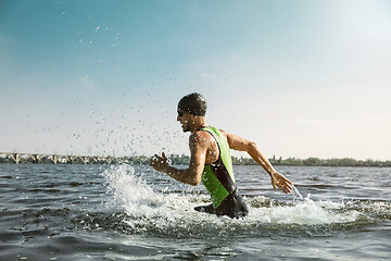 Image showing Professional triathlete swimming in river\'s open water