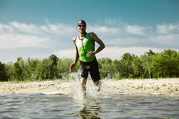 Image showing Professional triathlete swimming in river\'s open water