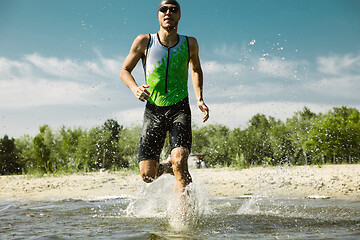 Image showing Professional triathlete swimming in river\'s open water