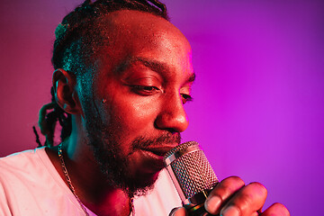 Image showing Young african-american jazz musician singing a song