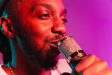 Image showing Young african-american jazz musician singing a song