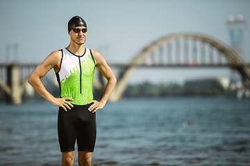 Image showing Professional triathlete swimming in river\'s open water