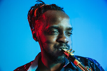 Image showing Young african-american jazz musician playing the saxophone