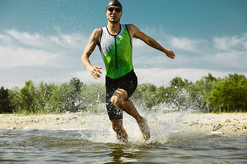 Image showing Professional triathlete swimming in river\'s open water