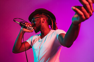 Image showing Young african-american jazz musician singing a song