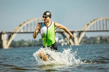 Image showing Professional triathlete swimming in river\'s open water