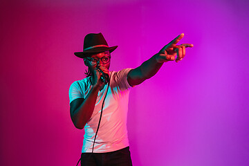 Image showing Young african-american jazz musician singing a song