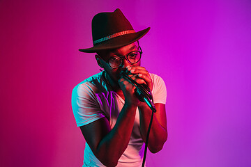 Image showing Young african-american jazz musician singing a song