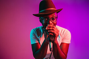 Image showing Young african-american jazz musician singing a song