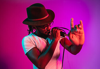 Image showing Young african-american jazz musician singing a song