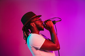 Image showing Young african-american jazz musician singing a song