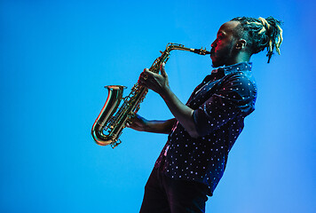 Image showing Young african-american jazz musician playing the saxophone