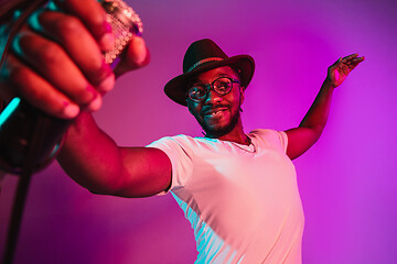 Image showing Young african-american jazz musician singing a song