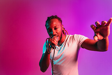 Image showing Young african-american jazz musician singing a song