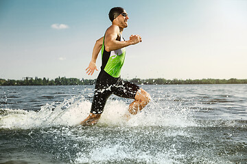 Image showing Professional triathlete swimming in river\'s open water