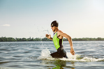 Image showing Professional triathlete swimming in river\'s open water