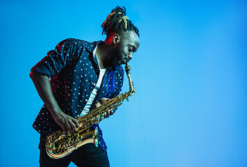 Image showing Young african-american jazz musician playing the saxophone