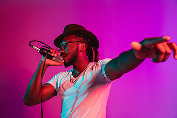 Image showing Young african-american jazz musician singing a song