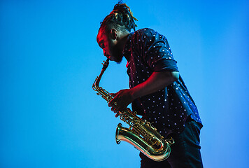 Image showing Young african-american jazz musician playing the saxophone