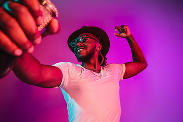 Image showing Young african-american jazz musician singing a song