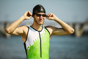 Image showing Professional triathlete swimming in river\'s open water