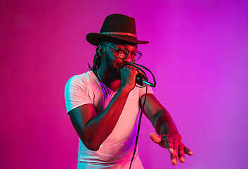 Image showing Young african-american jazz musician singing a song