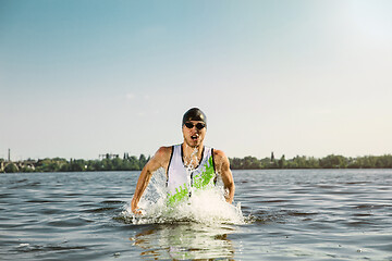 Image showing Professional triathlete swimming in river\'s open water