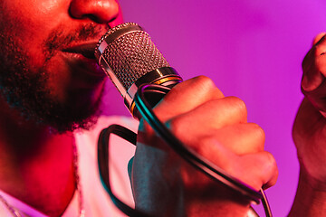 Image showing Young african-american jazz musician singing a song