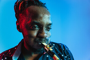 Image showing Young african-american jazz musician playing the saxophone