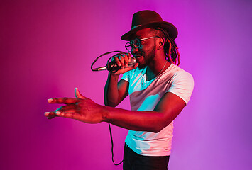 Image showing Young african-american jazz musician singing a song