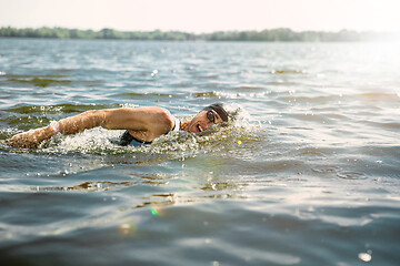 Image showing Professional triathlete swimming in river\'s open water