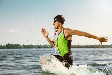 Image showing Professional triathlete swimming in river\'s open water